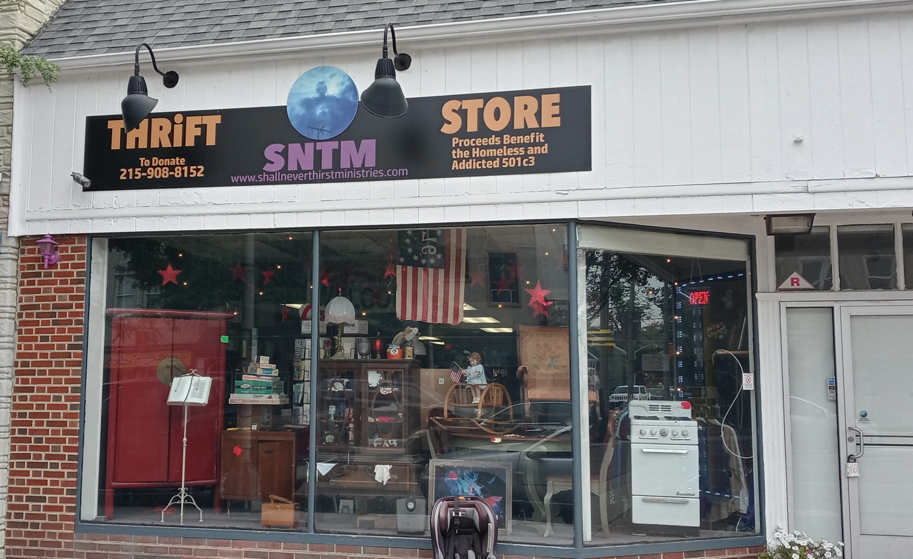 SNTM Thrift Store storefront on South Broad Street